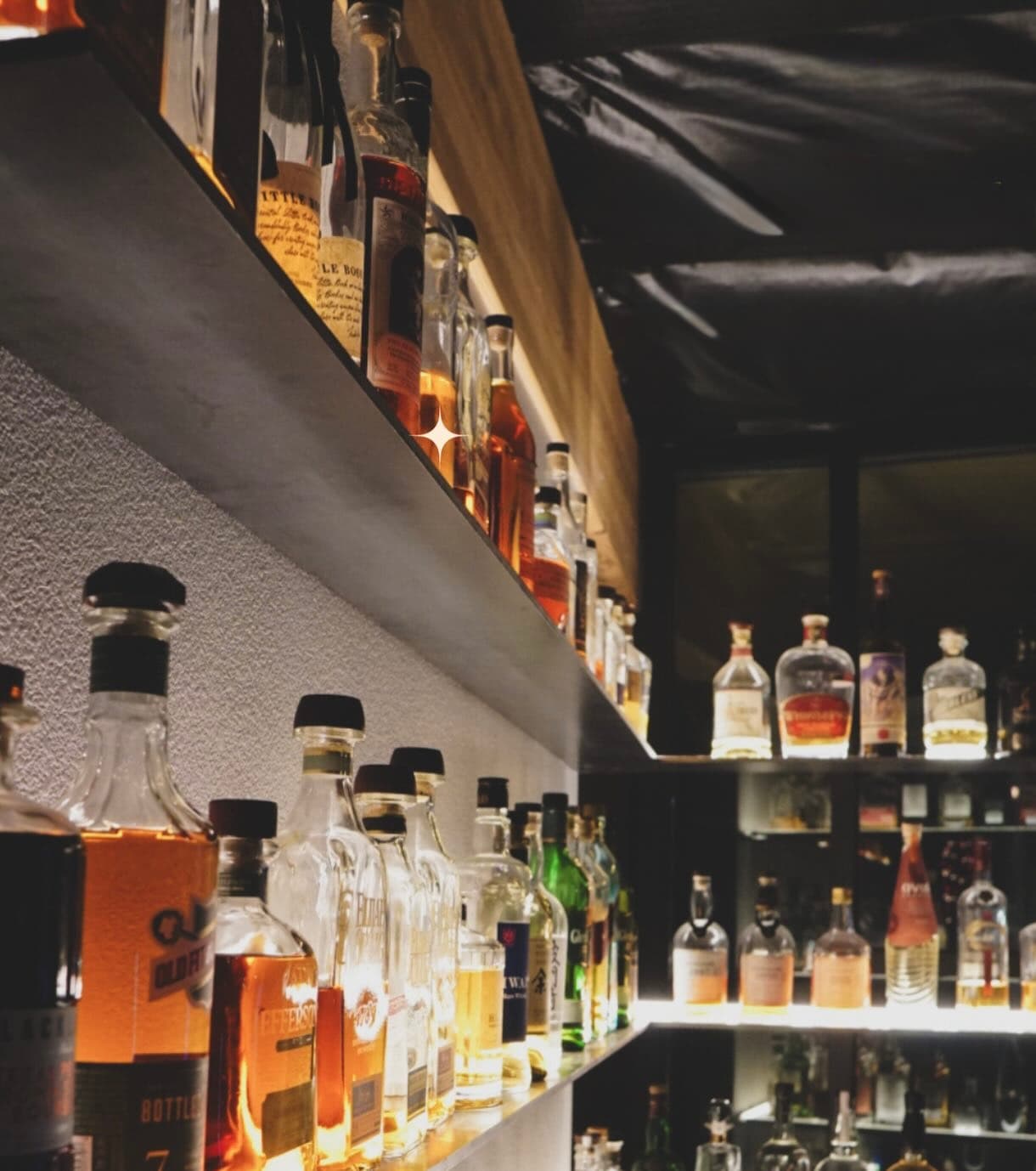 Illuminated whiskey selection inside Atlas Landing